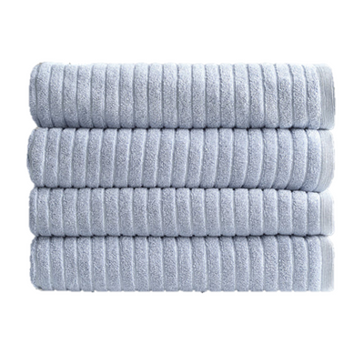 A stack of neatly folded, eco-friendly Alessia Cotton Bamboo Rib bath towels in Fresco Blue by Canningvale.